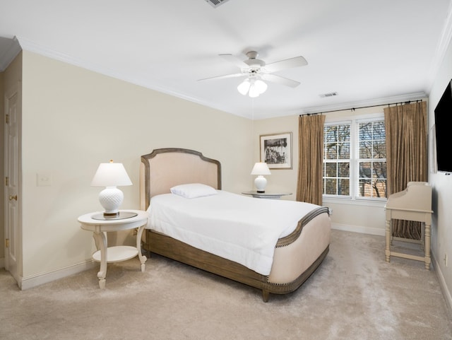 carpeted bedroom with ceiling fan and crown molding