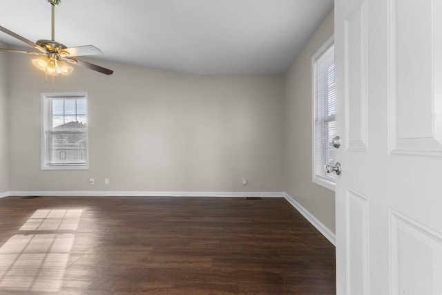 unfurnished room with dark hardwood / wood-style flooring and ceiling fan