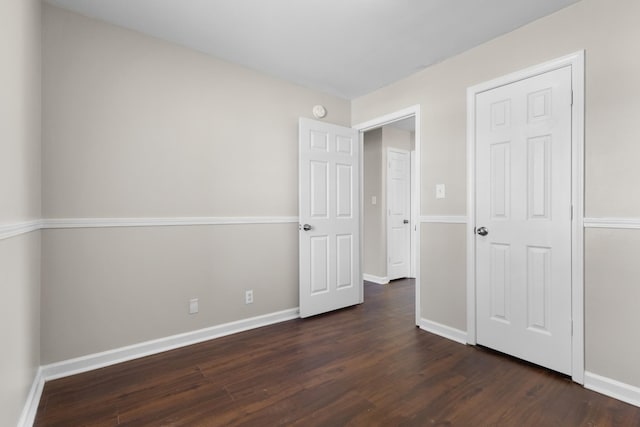 unfurnished bedroom featuring dark hardwood / wood-style flooring