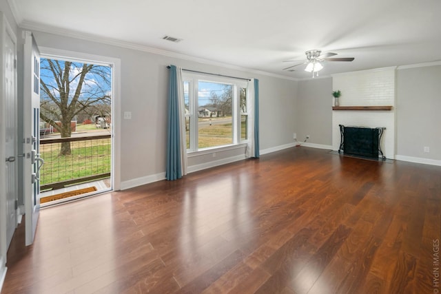 unfurnished living room with ceiling fan, ornamental molding, dark hardwood / wood-style floors, and a brick fireplace