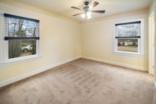 carpeted empty room featuring ceiling fan