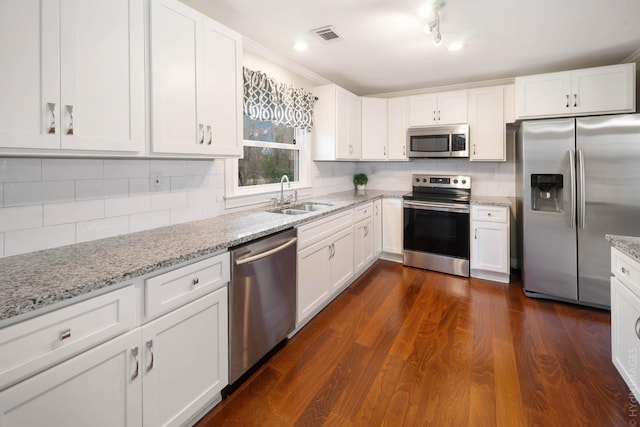 kitchen with white cabinetry, sink, decorative backsplash, stainless steel appliances, and dark wood-type flooring