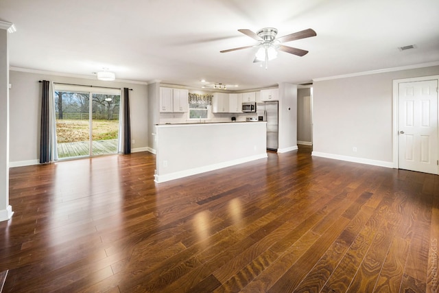 unfurnished living room featuring dark wood-type flooring, ornamental molding, and ceiling fan