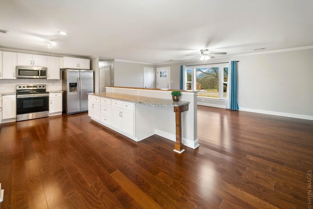 kitchen with stainless steel appliances, white cabinetry, tasteful backsplash, and ceiling fan