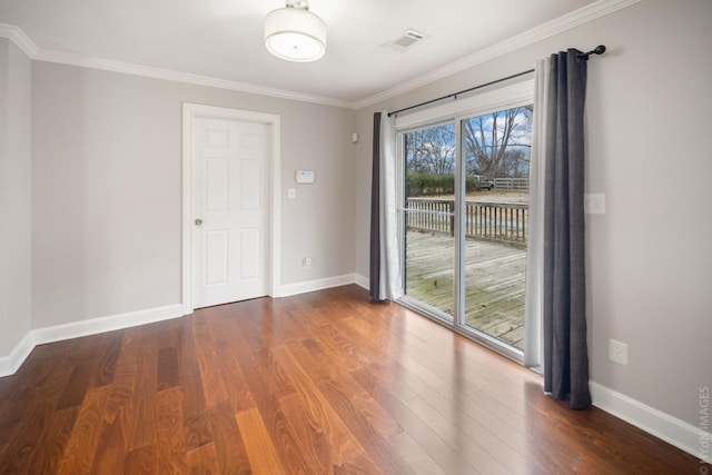 spare room featuring crown molding and dark hardwood / wood-style floors