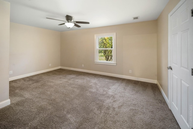 unfurnished room featuring ceiling fan and carpet