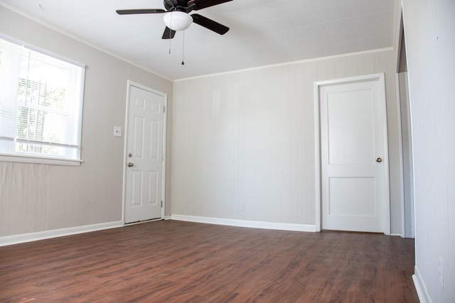 empty room featuring crown molding, ceiling fan, and dark hardwood / wood-style floors