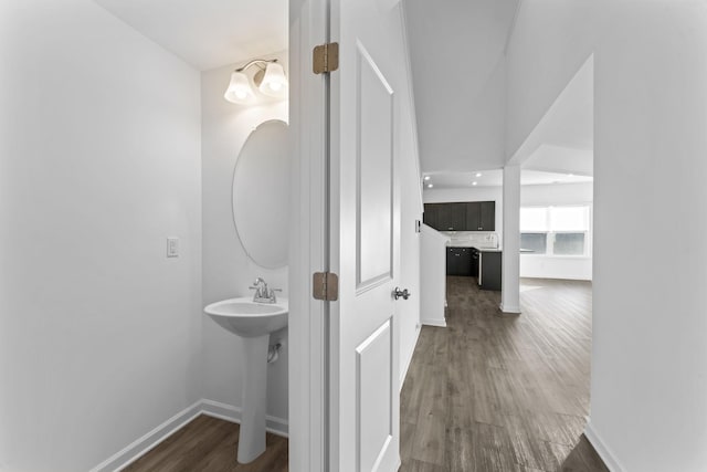 bathroom with a chandelier and wood-type flooring