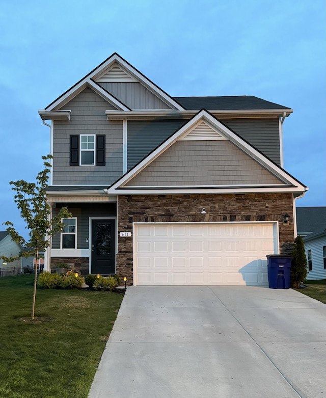 craftsman-style home with a garage and a front lawn