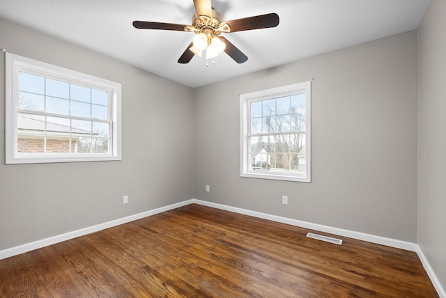 unfurnished room featuring hardwood / wood-style floors, ceiling fan, and a healthy amount of sunlight