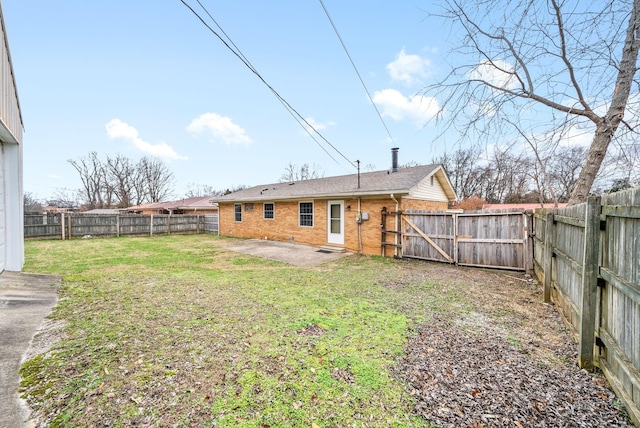 back of house featuring a yard and a patio