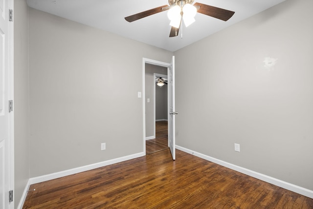 unfurnished room with ceiling fan and dark wood-type flooring