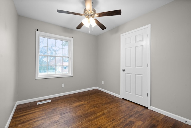 unfurnished room with ceiling fan and dark hardwood / wood-style floors