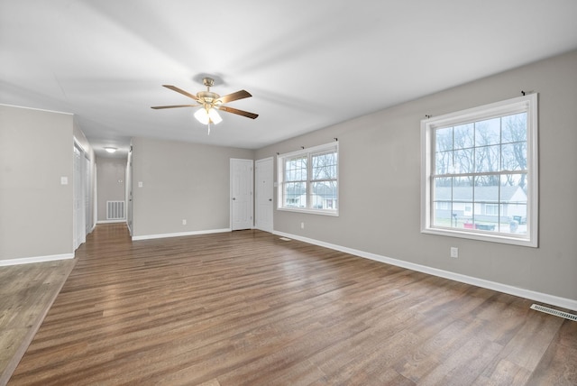 empty room featuring dark hardwood / wood-style floors and ceiling fan