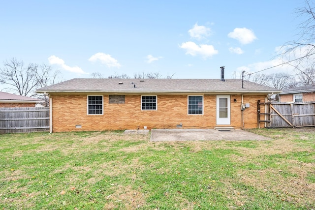 rear view of property with a lawn and a patio area