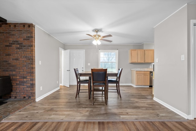 dining space with hardwood / wood-style flooring and ceiling fan