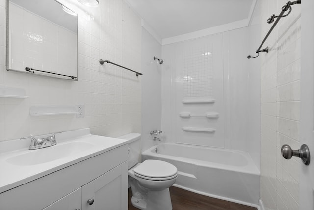 full bathroom with shower / bathing tub combination, wood-type flooring, toilet, vanity, and tile walls