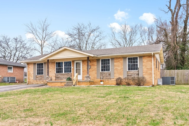 ranch-style home with a front lawn and central air condition unit