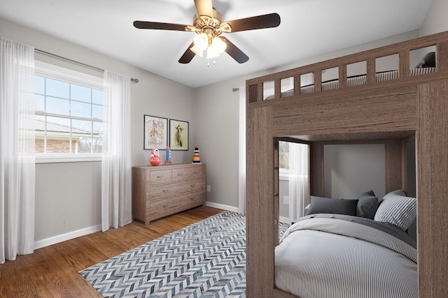 bedroom with ceiling fan and wood-type flooring