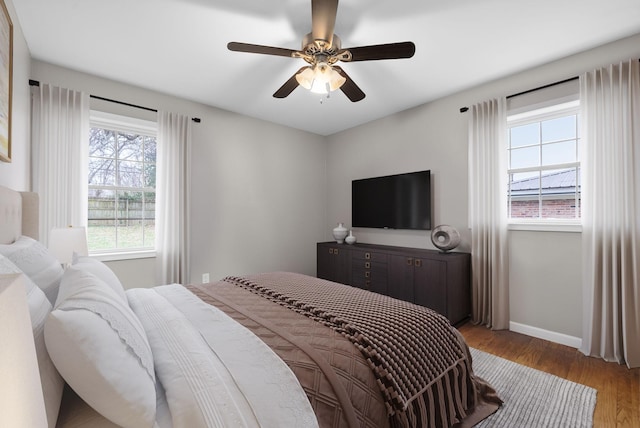 bedroom with hardwood / wood-style floors and ceiling fan