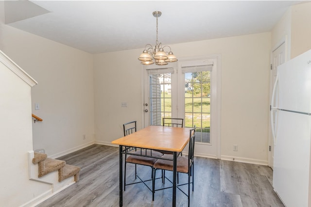 dining room featuring a chandelier and hardwood / wood-style floors