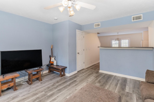 unfurnished living room featuring ceiling fan and light hardwood / wood-style flooring