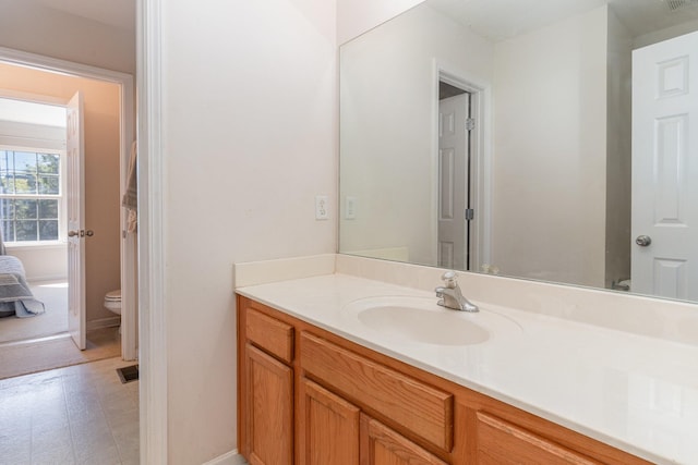 bathroom with vanity and toilet