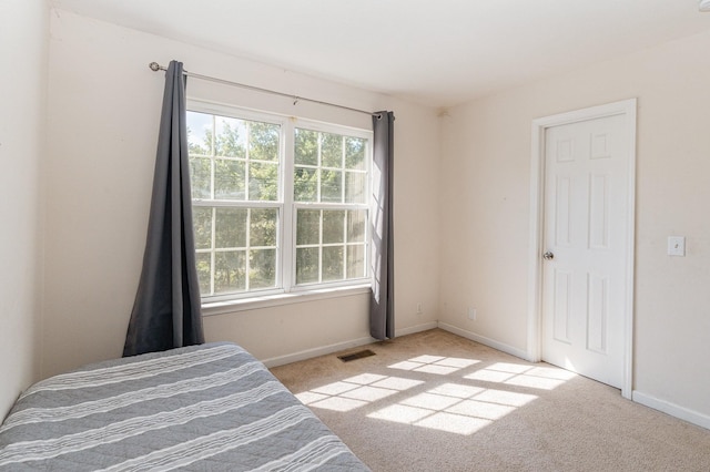 unfurnished bedroom featuring light colored carpet