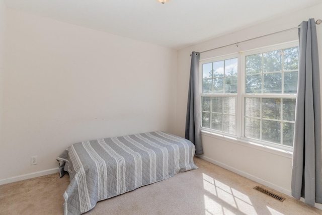 bedroom with light carpet