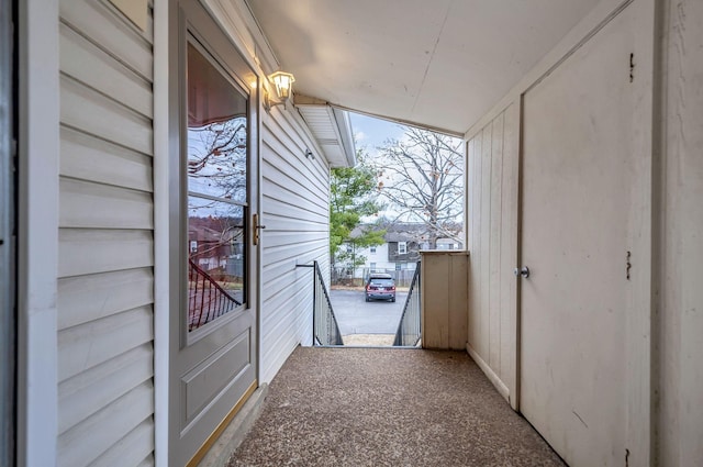 exterior space featuring carpet flooring and vaulted ceiling