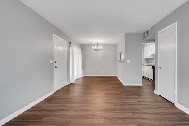 interior space featuring dark hardwood / wood-style flooring and a chandelier