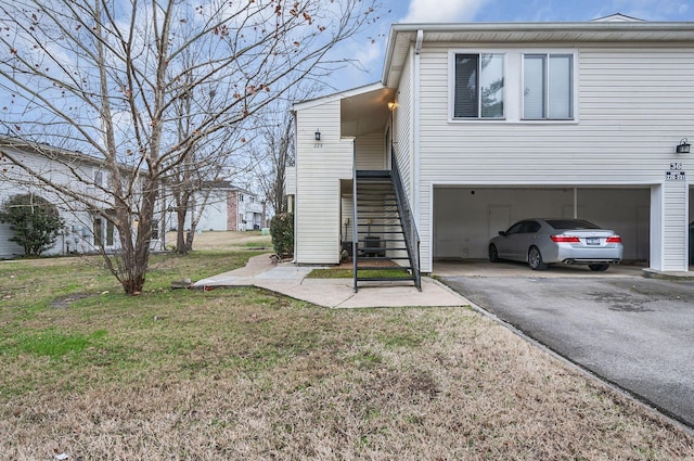 view of side of home with a yard and a garage