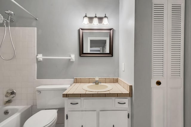 full bathroom with vanity, toilet, and tiled shower / bath combo