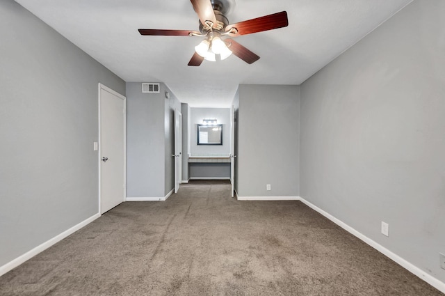 empty room with carpet floors and ceiling fan