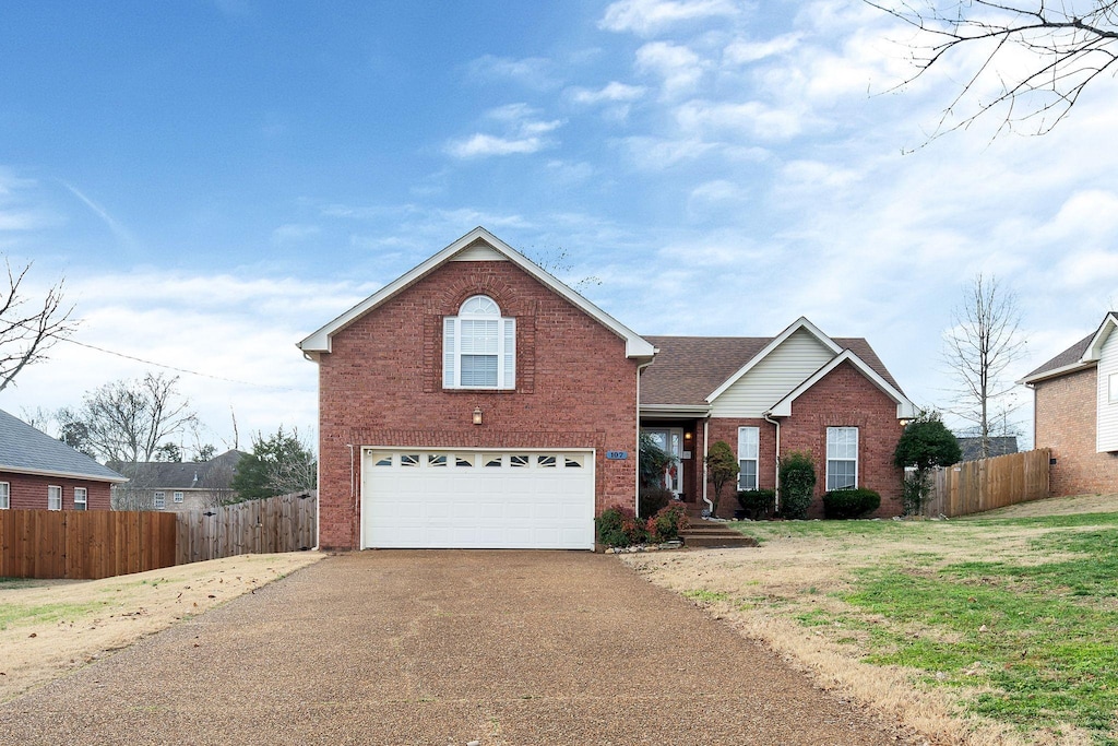 front of property featuring a front yard and a garage