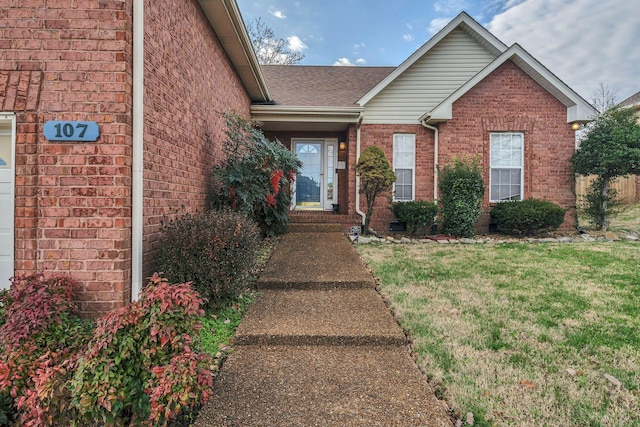 view of exterior entry with a lawn