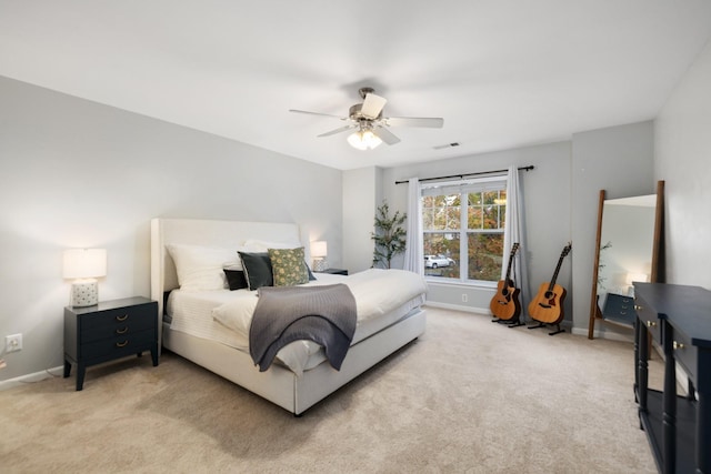 bedroom featuring ceiling fan and light carpet