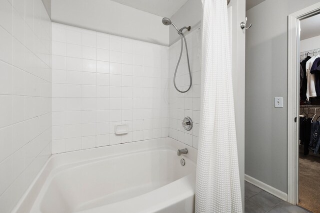 bathroom featuring tile patterned floors and shower / tub combo with curtain