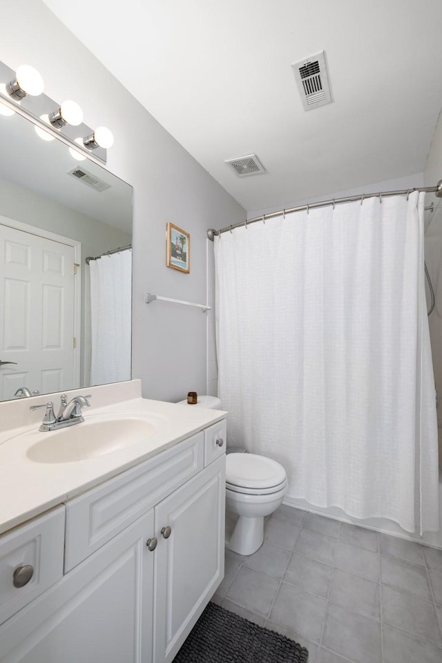 full bathroom with tile patterned flooring, shower / bath combo, vanity, and toilet