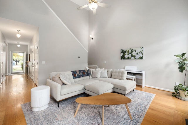 living room with hardwood / wood-style flooring and ceiling fan