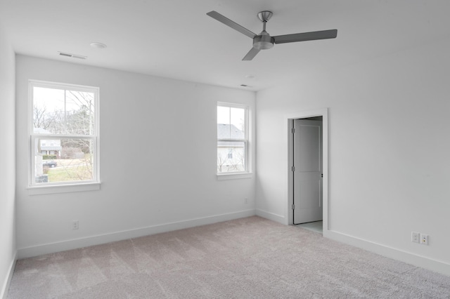 unfurnished room with ceiling fan and light carpet