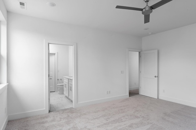 unfurnished bedroom with ceiling fan, connected bathroom, and light colored carpet