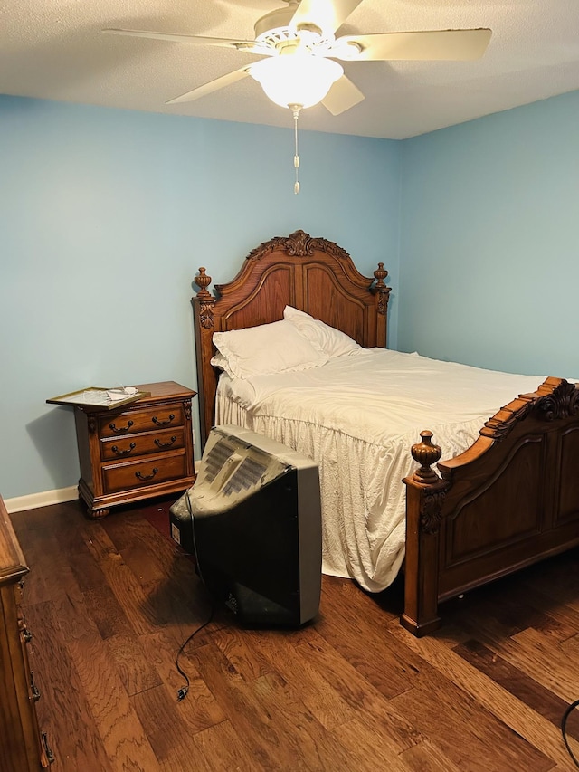 bedroom featuring dark hardwood / wood-style floors and ceiling fan