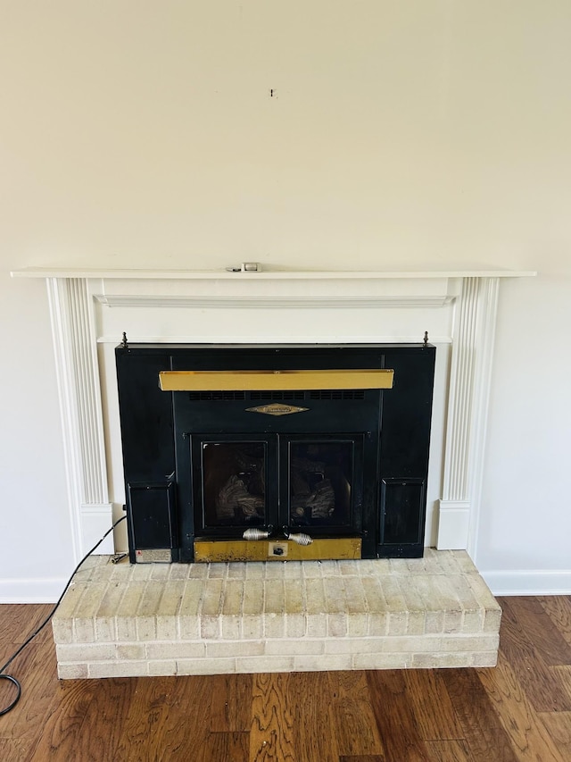 room details with hardwood / wood-style flooring and a brick fireplace