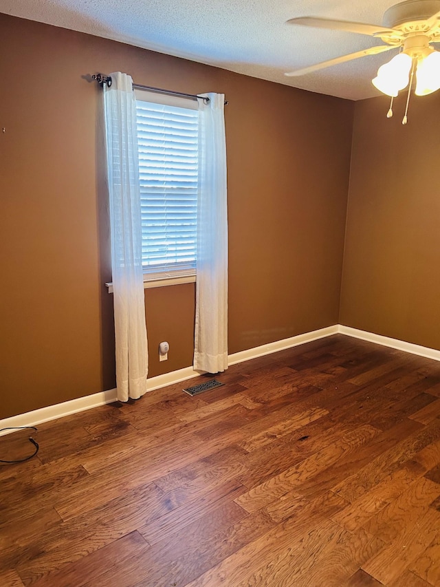 unfurnished room with ceiling fan, hardwood / wood-style floors, and a textured ceiling