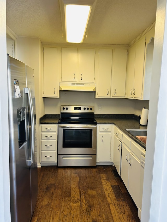 kitchen with white cabinets, stainless steel appliances, and dark wood-type flooring