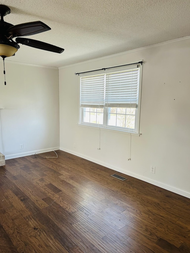 spare room with dark hardwood / wood-style flooring, a textured ceiling, ceiling fan, and ornamental molding