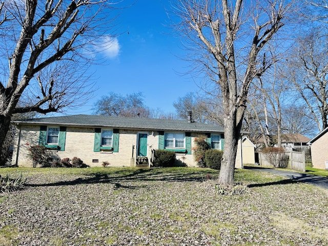 single story home featuring an outdoor structure and a front lawn