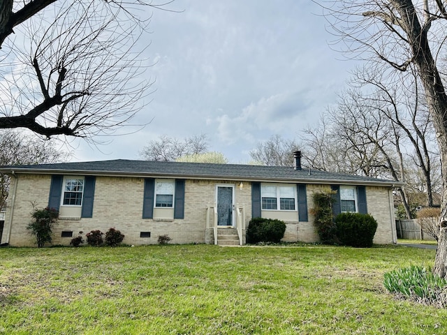 ranch-style home with a front yard, brick siding, roof with shingles, and crawl space