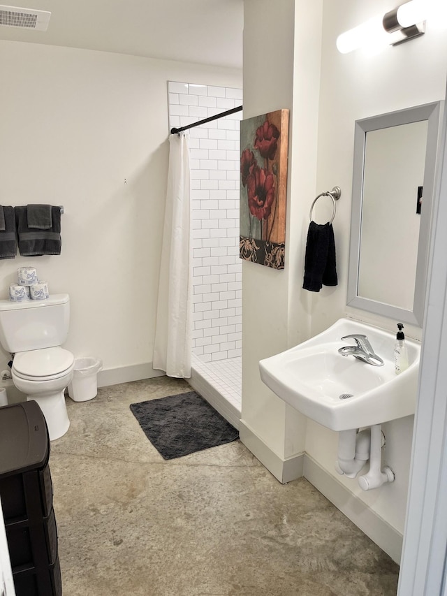 bathroom featuring toilet and walk in shower